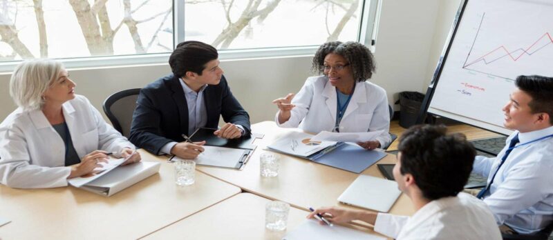 Healthcare team discussing care coordination in a meeting room